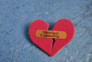 Broken red heart with a Marriage Counseling bandaid